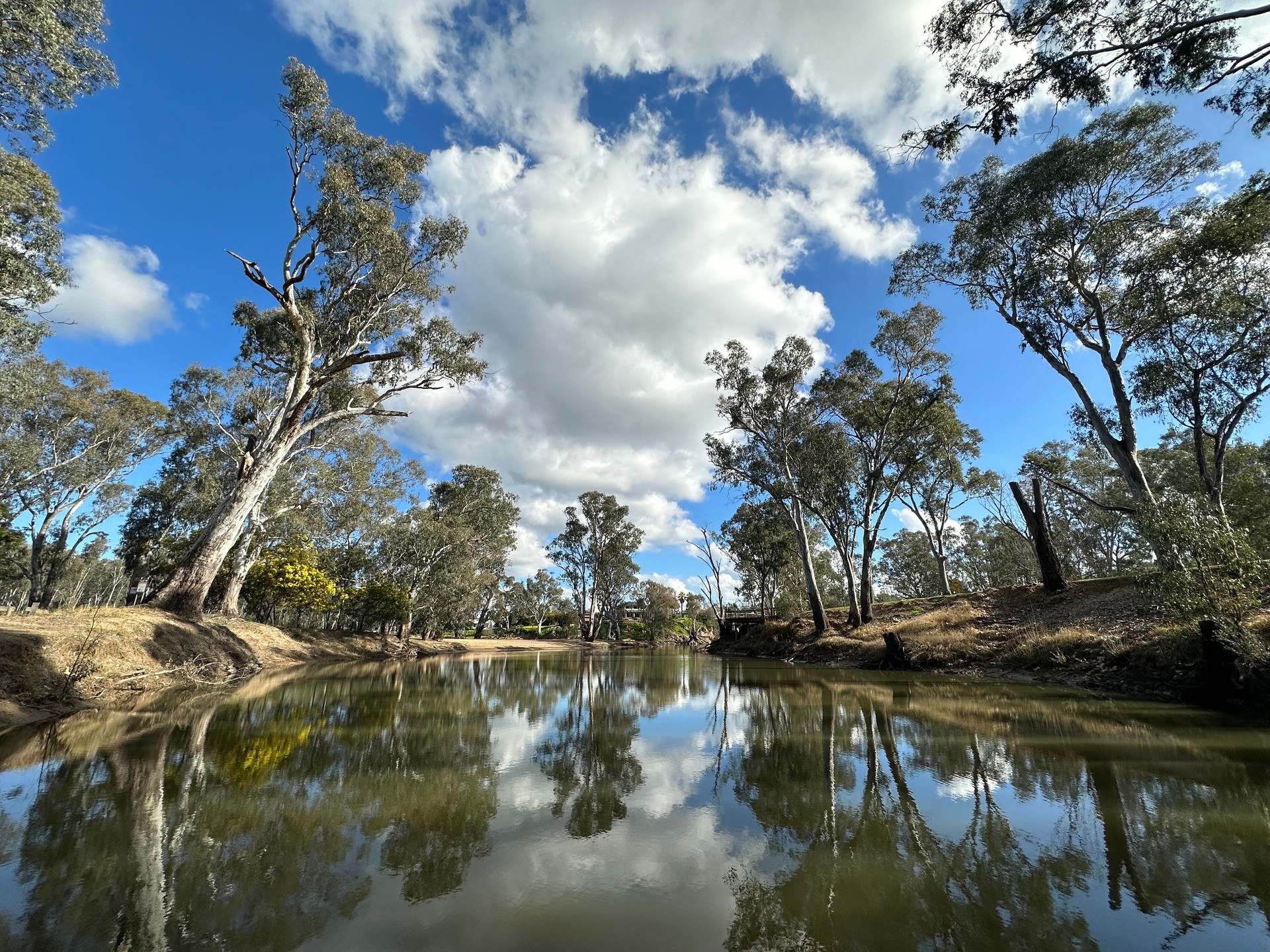 River reflections, trees and clouds